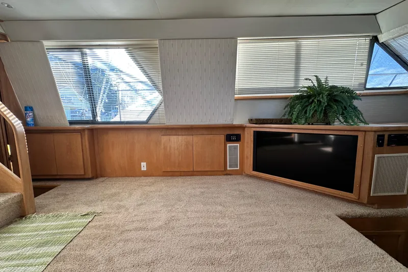 Slide: The Image of Interior of 1995 Carver 440 Aft Cabin Motor Yacht with carpet, TV, and potted plant. - 36