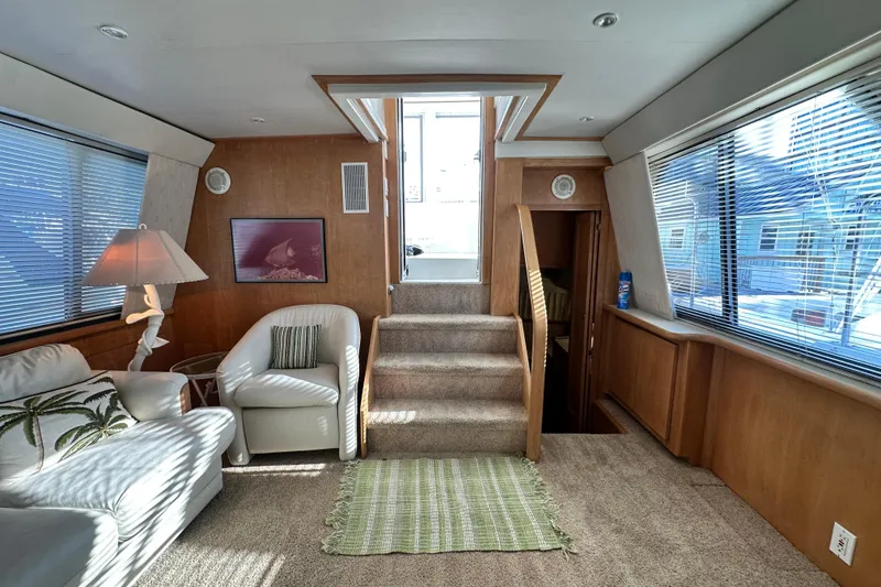 Slide: The Image of Interior of 1995 Carver 440 Aft Cabin Motor Yacht, featuring cozy seating and natural light. - 37