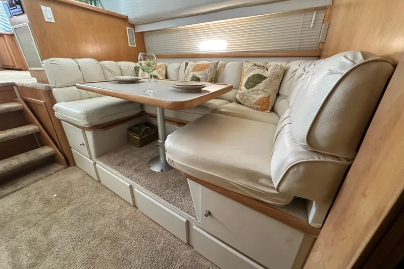 Slide: The Image of Luxurious dining area in 1995 Carver 440 Aft Cabin Motor Yacht with plush seating. - 46