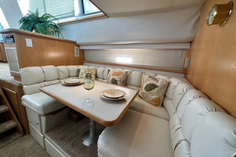 Slide: The Image of Cozy dining area in 1995 Carver 440 Aft Cabin Motor Yacht with plush seating and decor. - 48