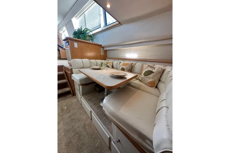 Slide: The Image of Luxurious 1995 Carver 440 Aft Cabin Motor Yacht interior with elegant dining area. - 49