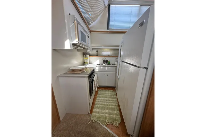 Slide: The Image of Compact kitchen in 1995 Carver 440 Aft Cabin Motor Yacht with modern appliances. - 50