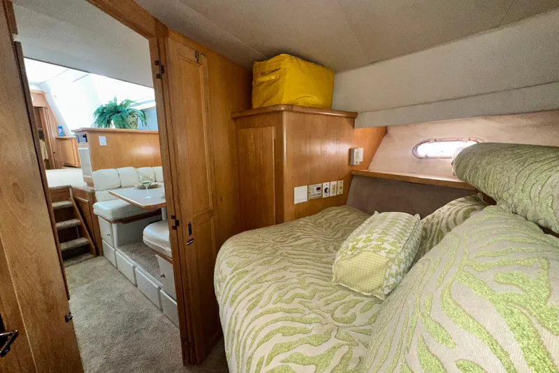 Slide: The Image of 1995 Carver 440 Aft Cabin Motor Yacht interior with cozy bedroom and dining area. - 61