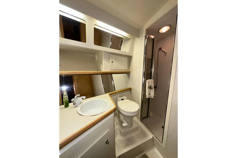 Slide: The Image of Bathroom of 1995 Carver 440 Aft Cabin Motor Yacht with shower, sink, and toilet. - 62