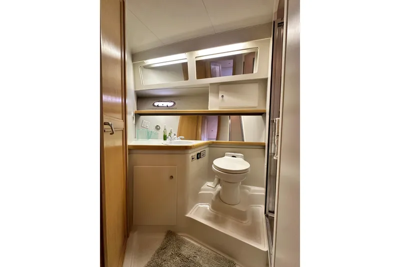 Slide: The Image of Bathroom interior of 1995 Carver 440 Aft Cabin Motor Yacht, featuring toilet and sink. - 64
