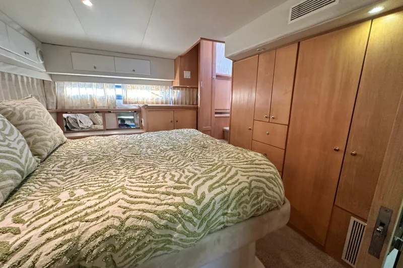 Slide: The Image of Luxurious bedroom in 1995 Carver 440 Aft Cabin Motor Yacht with elegant wood cabinetry. - 69