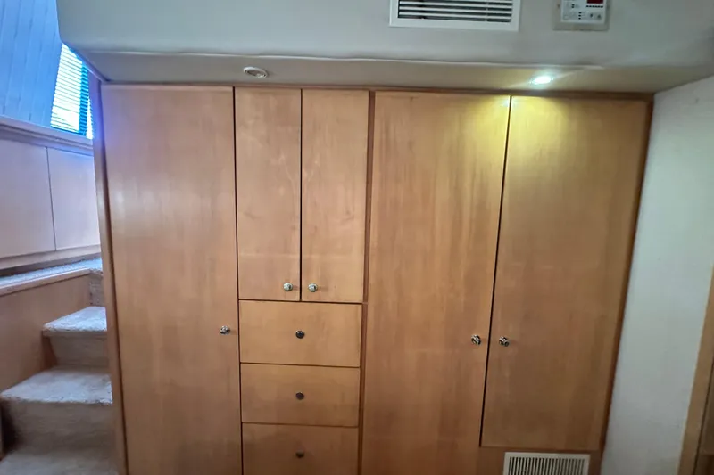 Slide: The Image of Wooden cabinetry inside 1995 Carver 440 Aft Cabin Motor Yacht, featuring drawers and storage. - 73