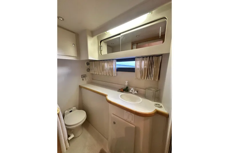 Slide: The Image of Bathroom interior of 1995 Carver 440 Aft Cabin Motor Yacht, featuring sink and toilet. - 74