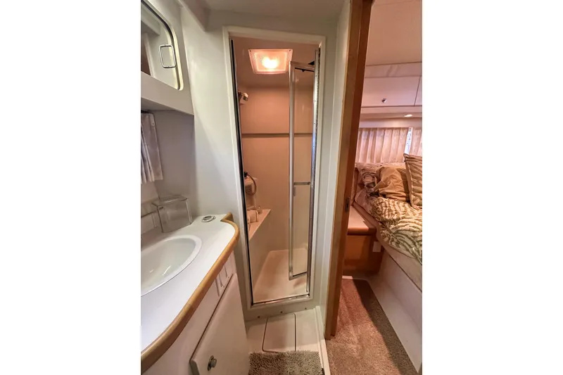 Slide: The Image of 1995 Carver 440 Aft Cabin Motor Yacht interior with bathroom and cozy bedroom. - 75