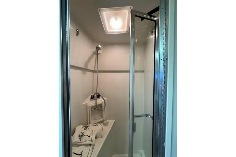 Slide: The Image of Shower area in 1995 Carver 440 Aft Cabin Motor Yacht with glass door and towels. - 76
