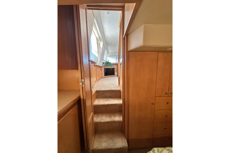 Slide: The Image of Interior of 1995 Carver 440 Aft Cabin Motor Yacht with wooden cabinetry and carpeted stairs. - 78