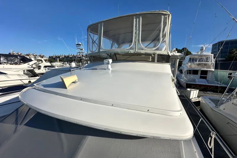Slide: The Image of 1995 Carver 440 Aft Cabin Motor Yacht docked at marina under clear blue sky. - 8