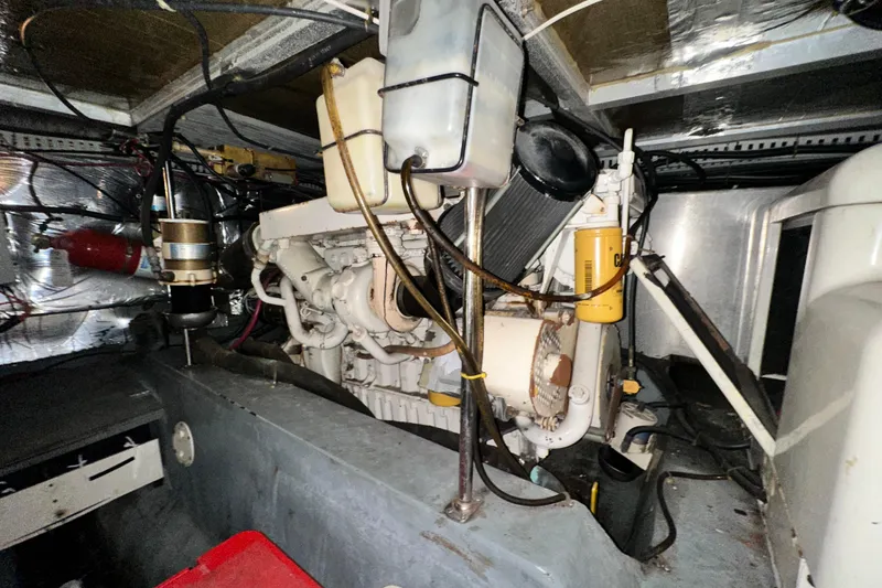 Slide: The Image of Engine room of a 1995 Carver 440 Aft Cabin Motor Yacht, showcasing mechanical components. - 80