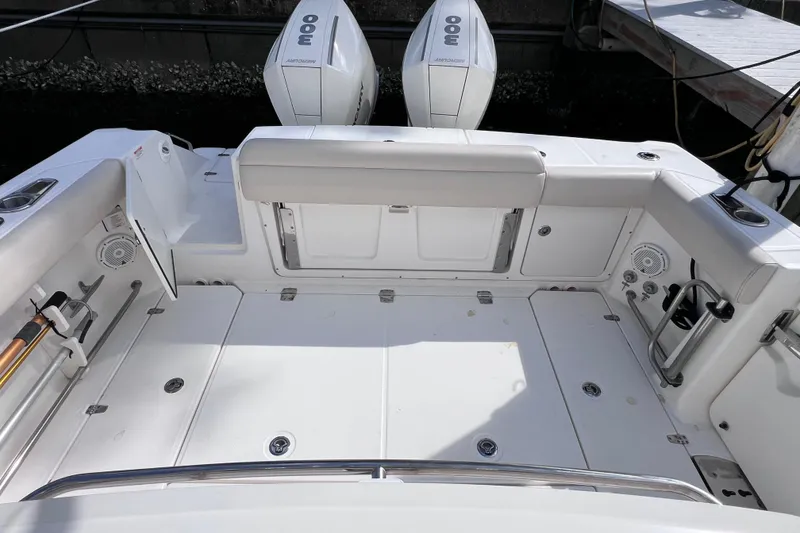 Slide: The Image of 2021 Boston Whaler 330 Outrage boat deck with dual Mercury engines, spacious and well-equipped. - 16
