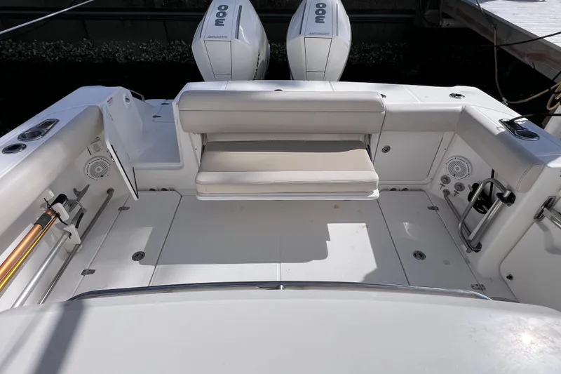 Slide: The Image of 2021 Boston Whaler 330 Outrage boat deck with seating and twin engines. - 17