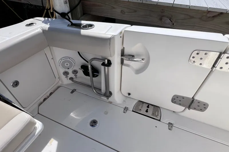 Slide: The Image of 2021 Boston Whaler 330 Outrage boat interior with seating and storage compartments. - 19