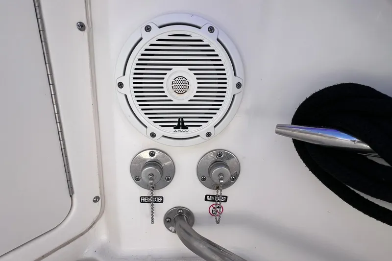 Slide: The Image of Speaker and water controls on a 2021 Boston Whaler 330 Outrage boat. - 21