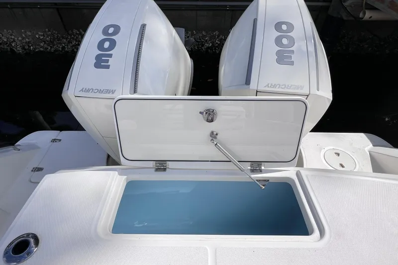 Slide: The Image of Boston Whaler 330 Outrage 2021 with dual Mercury 300 engines and open storage compartment. - 25
