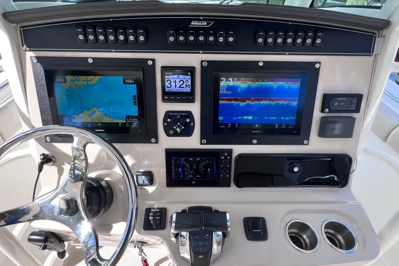 Slide: The Image of Control panel of a 2021 Boston Whaler 330 Outrage with navigation and sonar displays. - 37