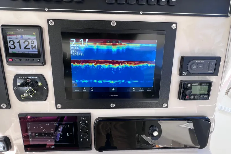 Slide: The Image of Control panel of 2021 Boston Whaler 330 Outrage with Garmin navigation and sonar display. - 38