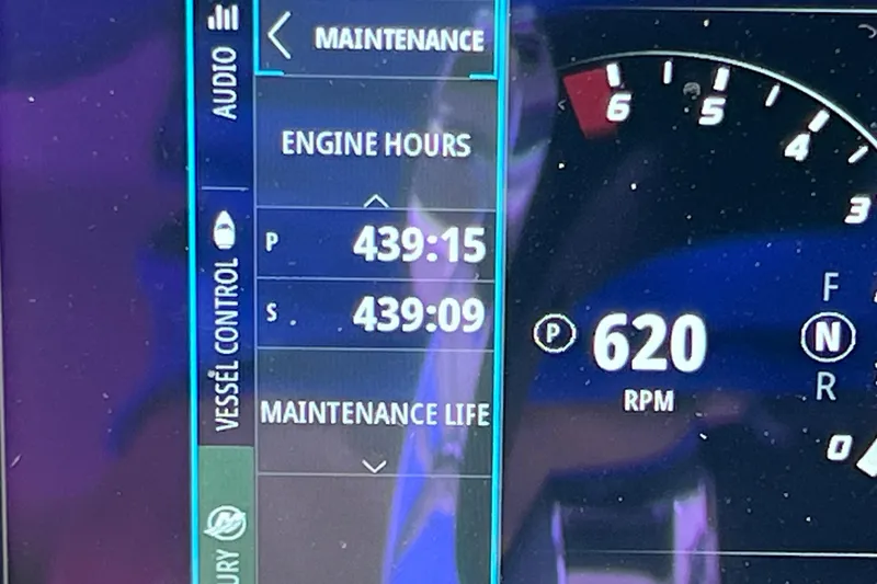 Slide: The Image of Dashboard of a 2021 Boston Whaler 330 Outrage showing engine hours and RPM. - 44