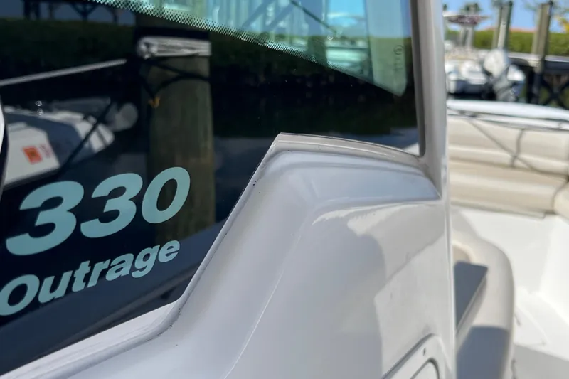 Slide: The Image of 2021 Boston Whaler 330 Outrage boat detail, showcasing sleek design and branding. - 52