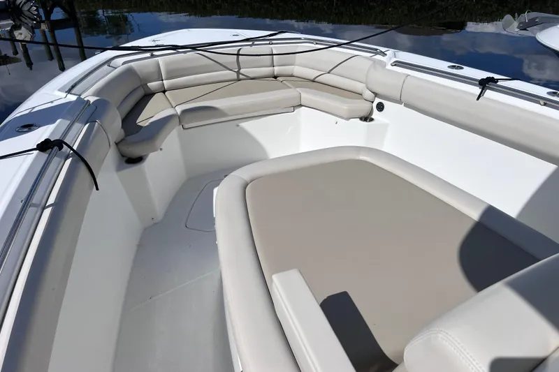 Slide: The Image of 2021 Boston Whaler 330 Outrage boat interior with cushioned seating. - 53