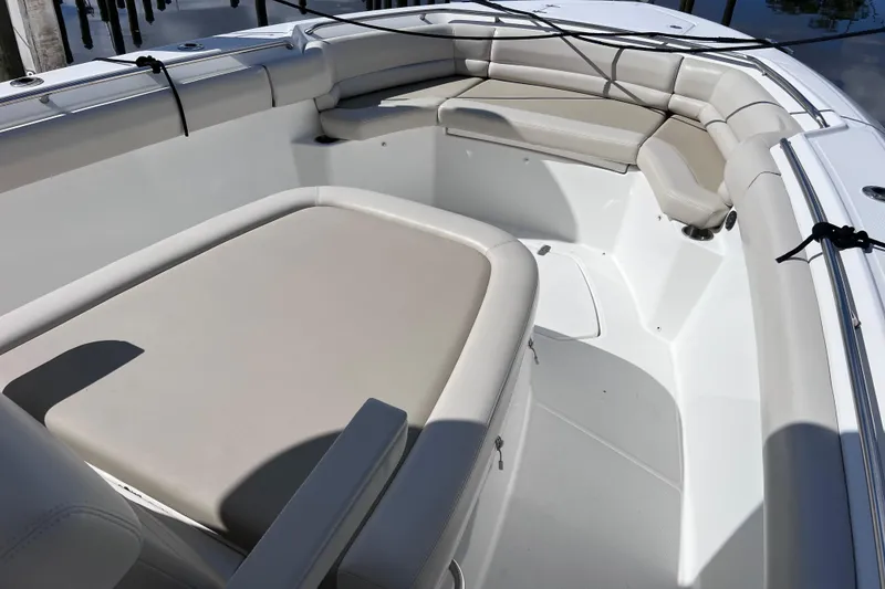 Slide: The Image of 2021 Boston Whaler 330 Outrage boat interior with cushioned seating and sleek design. - 54