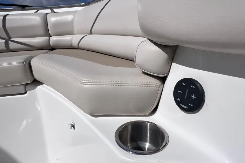 Slide: The Image of 2021 Boston Whaler 330 Outrage interior with cushioned seating and audio controls. - 56