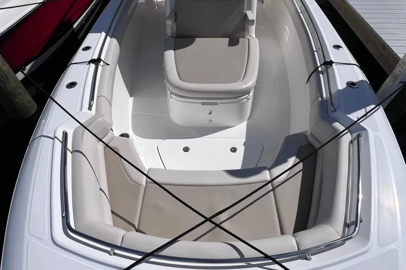 Slide: The Image of 2021 Boston Whaler 330 Outrage boat interior with cushioned seating and sleek design. - 58