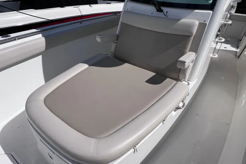 Slide: The Image of 2021 Boston Whaler 330 Outrage boat seat, featuring comfortable beige upholstery. - 59