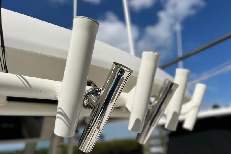 Slide: The Image of Rod holders on a 2021 Boston Whaler 330 Outrage against a blue sky. - 66