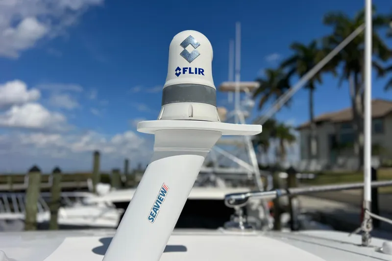 Slide: The Image of FLIR camera on 2021 Boston Whaler 330 Outrage boat, clear sky background. - 70