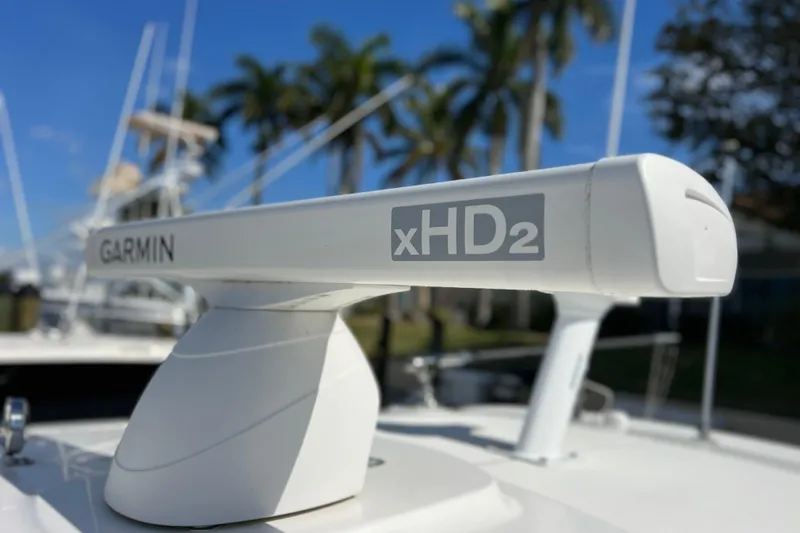 Slide: The Image of Garmin xHD2 radar on 2021 Boston Whaler 330 Outrage boat, with palm trees in background. - 71