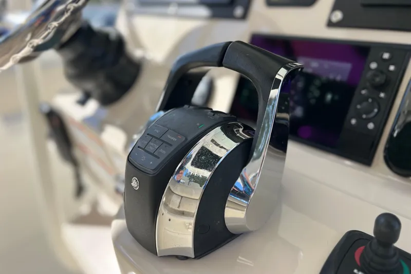 Slide: The Image of Close-up of 2021 Boston Whaler 330 Outrage boat controls and dashboard. - 74