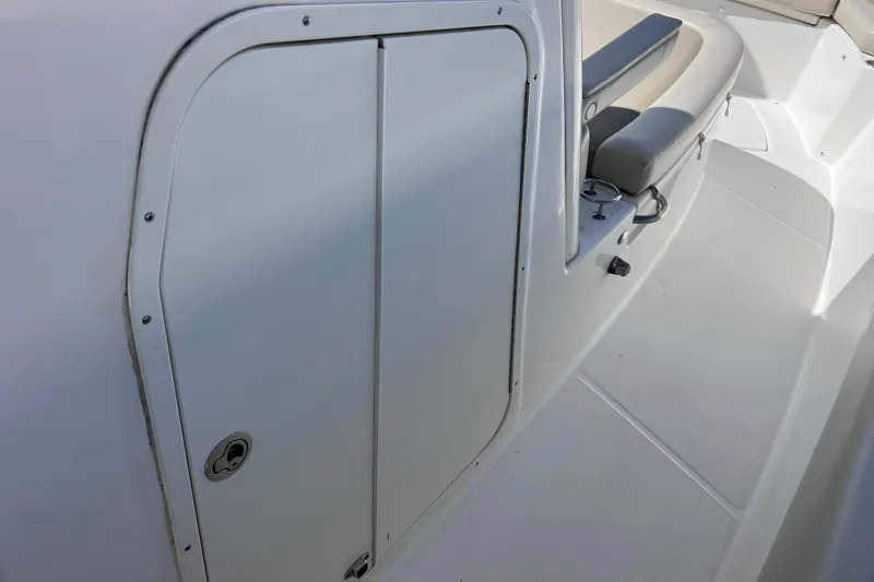 Slide: The Image of 2021 Boston Whaler 330 Outrage interior with seating and storage compartment. - 78