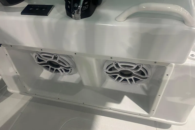 Slide: The Image of 2024 Yellowfin 36 Offshore boat speakers and controls on white console. - 10