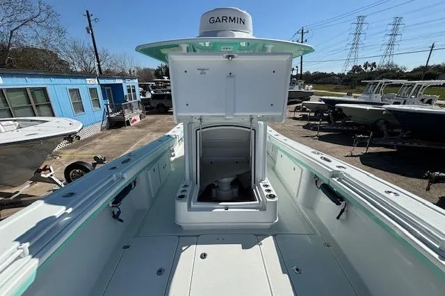 Slide: The Image of 2024 Yellowfin 36 Offshore boat with open storage compartment, Garmin equipment, and docked in a marina. - 14