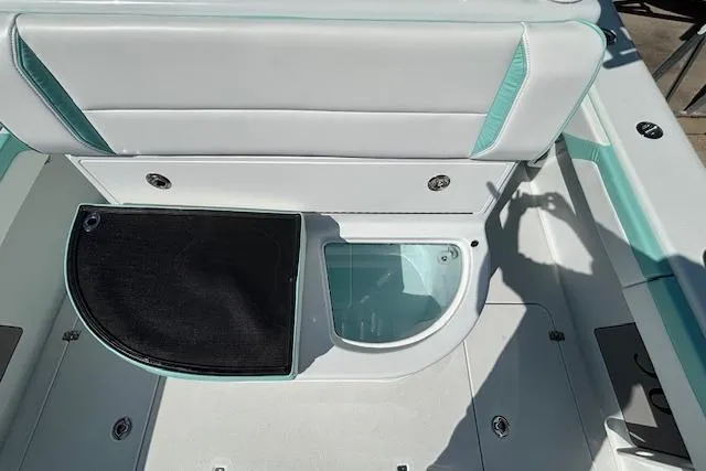 Slide: The Image of 2024 Yellowfin 36 Offshore boat interior with storage compartment and seating. - 15