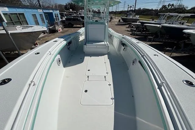 Slide: The Image of 2024 Yellowfin 36 Offshore boat, spacious deck, sleek design, parked at a marina. - 18