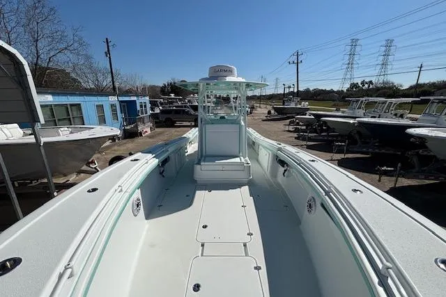 Slide: The Image of 2024 Yellowfin 36 Offshore boat, spacious deck, parked at marina under clear blue sky. - 19