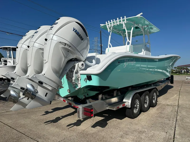 Slide: The Image of 2024 Yellowfin 36 Offshore boat with triple Yamaha engines on a trailer. - 7