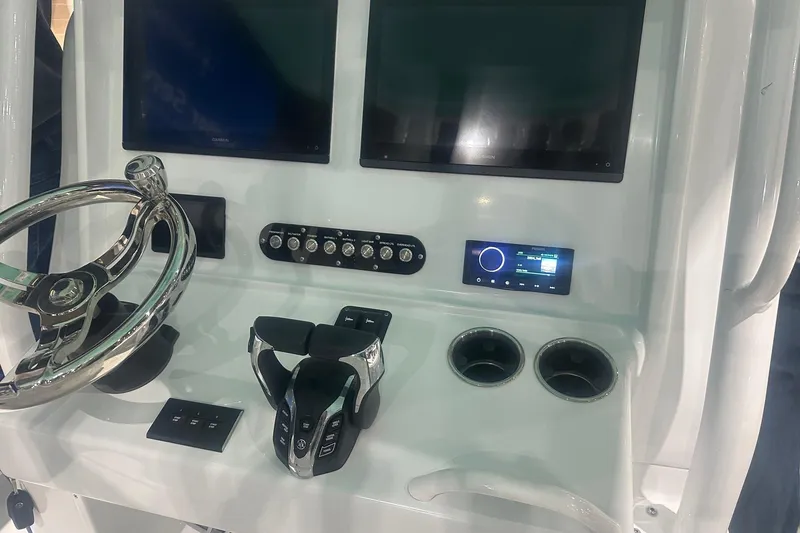 Slide: The Image of 2024 Yellowfin 36 Offshore boat dashboard with dual screens and modern controls. - 9