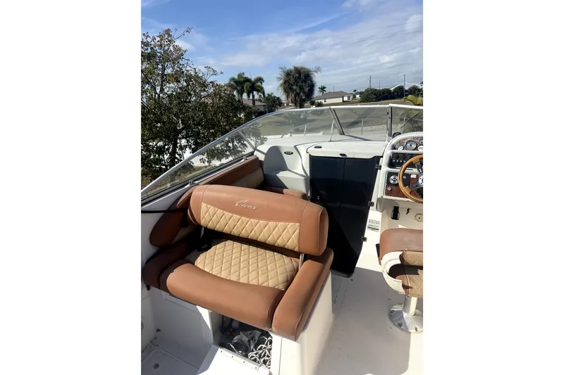 Slide: The Image of 1998 Bayliner 2355 Ciera boat interior with tan seating and steering console. - 3