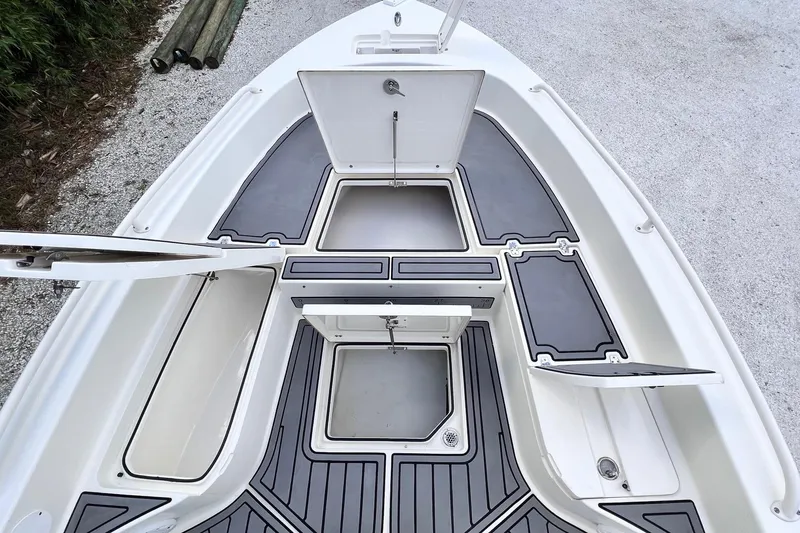 Slide: The Image of 2015 Pathfinder 2600 HPS boat deck with open storage compartments and sleek design. - 14
