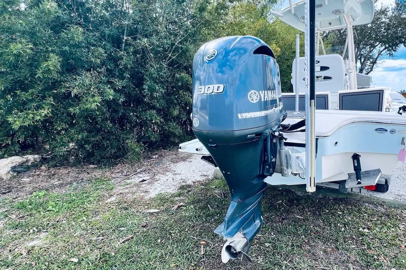 Slide: The Image of 2015 Pathfinder 2600 HPS boat with Yamaha 300 outboard motor, parked on grass. - 10