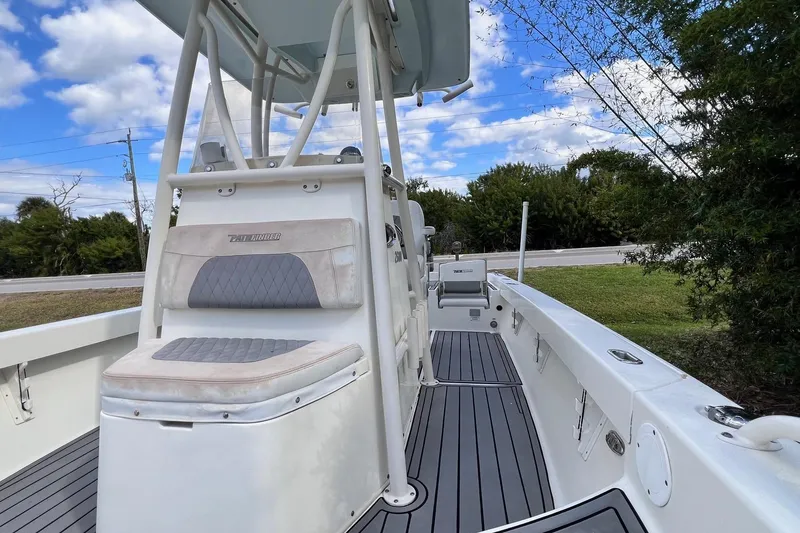 Slide: The Image of 2015 Pathfinder 2600 HPS boat interior with seating and console, under blue sky. - 17