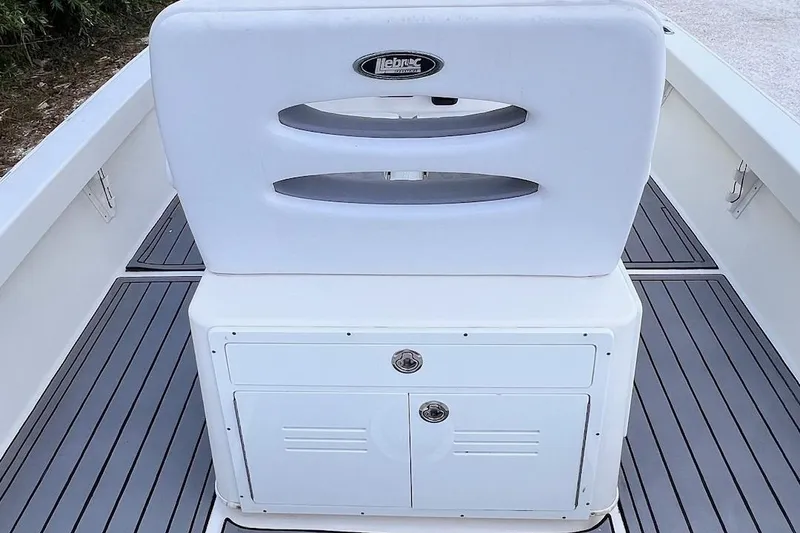 Slide: The Image of 2015 Pathfinder 2600 HPS boat interior with white seating and storage compartment. - 19