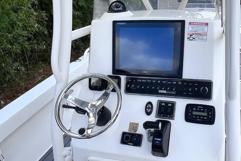 Slide: The Image of 2015 Pathfinder 2600 HPS boat console with steering wheel and navigation display. - 20