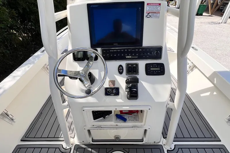 Slide: The Image of 2015 Pathfinder 2600 HPS boat console with steering wheel and navigation controls. - 21